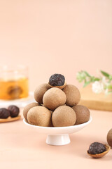 Guangdong Style Sweet Cinnamon Dumplings on White Stand Pink Background