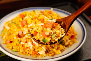 Golden Yangzhou Fried Rice with Egg and Vegetables Traditional Chinese Food Dish on White Plate