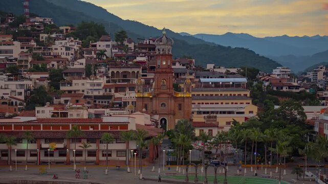 Timelapse of Puerto Vallarta church and boardwalk with moving clouds