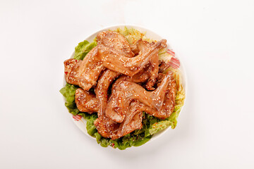 Szechuan Roasted Rabbit Legs Chinese Dish with Sesame Seeds and Lettuce Garnish