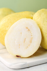 Fresh White Guava Fruit Sliced Showing Cream Flesh and Seeds on Marble Board