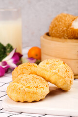 Crispy Golden Puff Pastry Dessert Balls with Milk and Bamboo Steamer Traditional Asian Sweet Treat