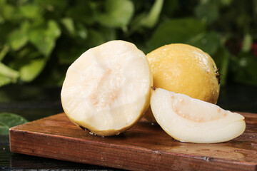 Fresh White Guava Fruit Sliced on Wooden Board - Tropical Guangxi Produce with Cream Flesh