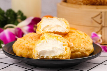 Delicious cream puffs with sweet filling and savory flavors on elegant serving plate