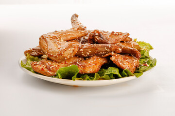 Szechuan Style Roasted Rabbit Legs with Sesame Seeds on Fresh Lettuce - Traditional Chinese Cuisine
