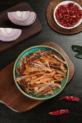 Traditional Dried Chicken Jerky with Spices and Vegetables on Wooden Table