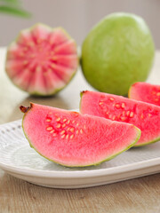 Fresh Guava Fruit Slices with Pink Flesh on White Plate - Tropical Guangxi Produce
