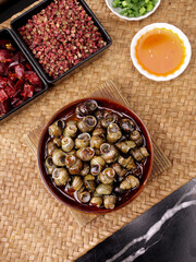 Spicy Stir-Fried Whelk Meat with Scallions and Seasonings on Bamboo Kitchen Mat