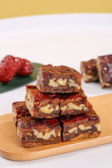 Xinjiang Date Walnut Jujube Bars Traditional Chinese Healthy Snack on Wooden Cutting Board