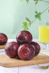 Fresh Thai Mangosteen Tropical Fruit on Wooden Board with Orange Juice Glass