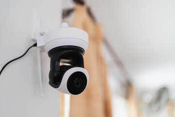 Indoor security camera mounted on a wall providing monitoring and surveillance for home or office...