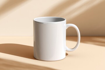 Fototapeta premium Simple White Coffee Mug on Beige Background with Soft Shadows