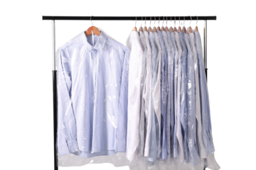 Garments in protective plastic garment bags on rack