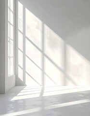 Obraz premium Sunlight streams through large windows, casting soft shadows on a white room
