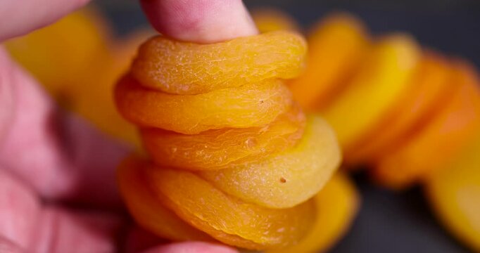 dried ripe orange apricot fruits on a black board, dried seedless pure dried apricots for long-term storage and used as a sweet or for making compotes