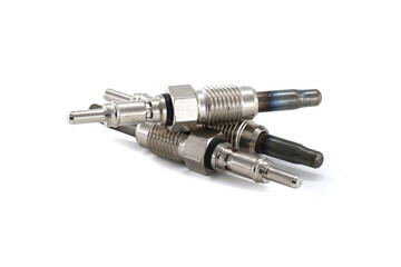 Close-up view of several new glow plugs, key components for diesel engine ignition, on white.