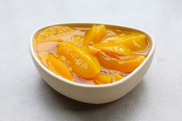 Sliced peaches in syrup served in a bowl