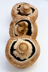 Fresh portobello mushrooms with visible gills underneath.