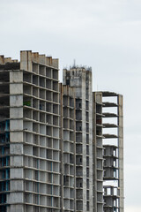 Fototapeta premium Urban decay abandoned concrete towers in a grey sky architectural dystopian environment wide angle view