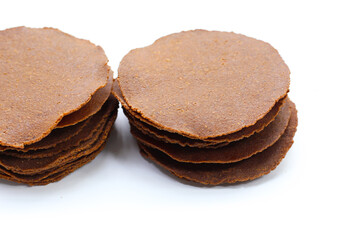 Fermented soybean discs, known as “Thua Nao,” a traditional Thai seasoning used to enhance flavor in Northern cuisine.