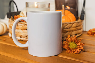 A blank white mug surrounded by autumn-themed decorations