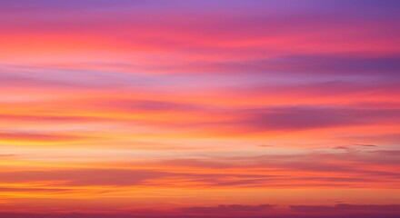 Stunning vibrant sunset sky with fiery orange and soft purple clouds