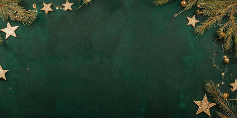 A textured christmas background with a dark green background and decorations for the holidays, with space for text. Festive dark background for Christmas, horizontal banner, copy space