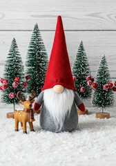 Festive gnome decoration with red hat and wooden reindeer in snowy winter scene surrounded by miniature Christmas trees