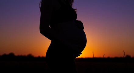 Silhouette of pregnant person sunset