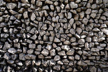 Stone wall with pattern. Rock wall background for architecture. Textured stonework on building facade. Historic stone wall with aged bricks. Stone material for construction and design.