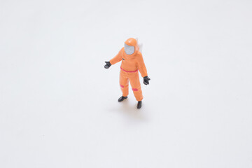 A Tiny Orange Astronaut Figure Walking Across
