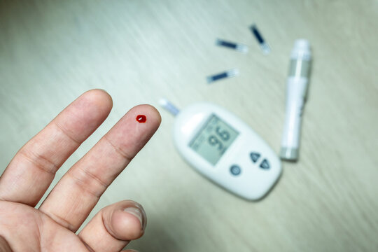 hand of people check diabetes and high blood glucose monitor with digital pressure gauge. Healthcare and Medical concept	
 - Powered by Adobe