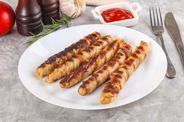 Grilled meat sausages wrapped bacon
