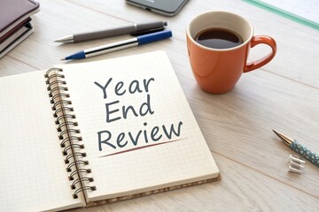 Year-End Review with Coffee and Stationery on a Desk, Emphasizing Reflection and Planning
