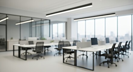 Fototapeta premium Modern blurred office interior with desks, chairs, and computers. Bright daylight through large glass windows creates a clean, minimal, and professional work environment with a soft focus aesthetic.