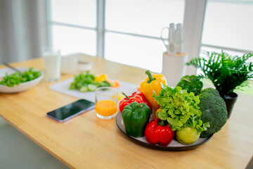 Woman holding fresh salad bowl with vegetables, promoting healthy eating, organic lifestyle, and balanced diet in a colorful kitchen setting.
