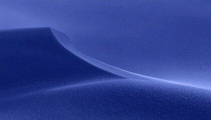 Abstract flowing curves of a deep blue desert landscape under soft light