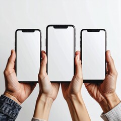 Three hands raise up mobile phones against a plain white background, showcasing the screen. Focus is on the mobile device displays