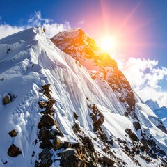Snowy peak reaching for the sky, illuminated by a bright sun, casts long shadows on the mountain's rugged terrain under a clear blue sky