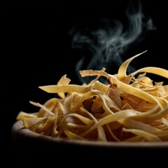 Close-up of steaming hot peelings with smoke rising on black background highlighting textures and warm tones of food preparation and cooking process