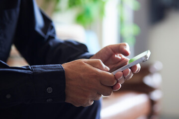 スマートフォンを操作する日本人シニア男性の手元