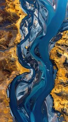 Winding turquoise river flows through a yellow, rocky landscape. An aerial view shows the intricate patterns of the river's braided channels