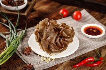 Fototapeta premium Buckwheat Noodles with Chili Oil and Fresh Vegetables on Wooden Table