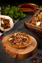 Five spice seasoning collection in wooden bowls for hot stew and meat cooking on dark slate background