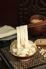 Fresh Handmade Tofu Skin Sheets in Wooden Bowl with Chopsticks - Traditional Asian Cooking Ingredient