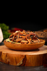 Mixed Spices with Cinnamon and Star Anise in Wooden Bowl on Rustic Wood Surface