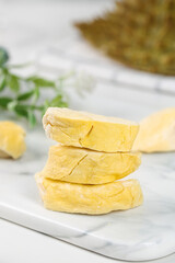 Freeze Dried Durian Fruit Slices Stacked on Marble Board - Exotic Asian Tropical Specialty Snack