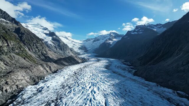 Expansive glacier system slowly flows down a mountain valley, captured in a dramatic long-term timelapse sequence mountain, slowly flows, icefield