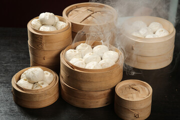Traditional Chinese Steamed Dumplings and Bao Buns in Bamboo Steamers - Authentic Dim Sum Cuisine