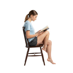 Contemplative young woman absorbed in reading a book, sitting comfortably on a chair in solitude